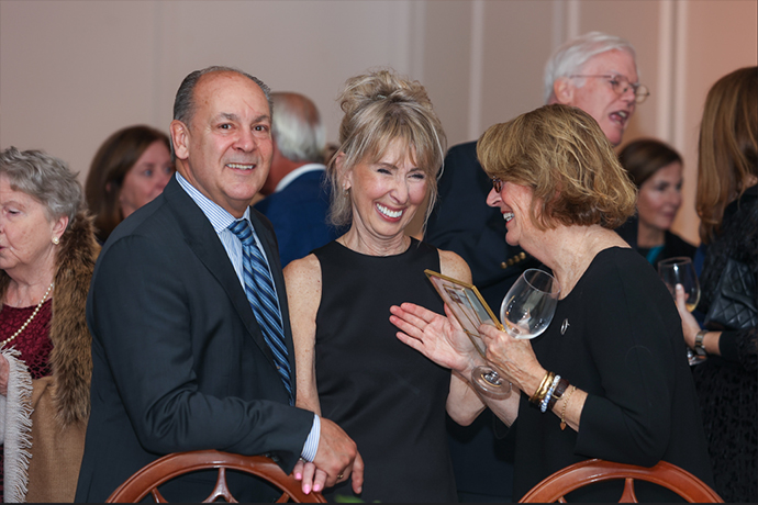 Denise Clofine enjoying a conversation with Mary Parker and a gentleman